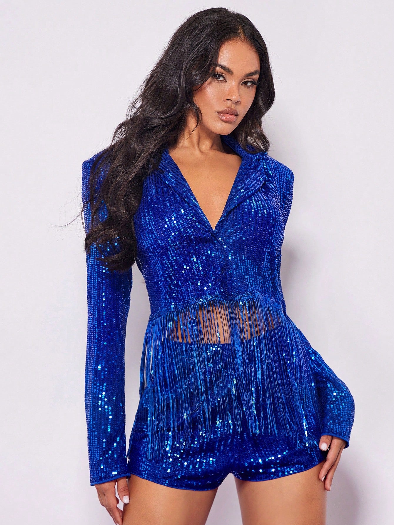 Blue sequin jacket worn by a model on a white background for product picture