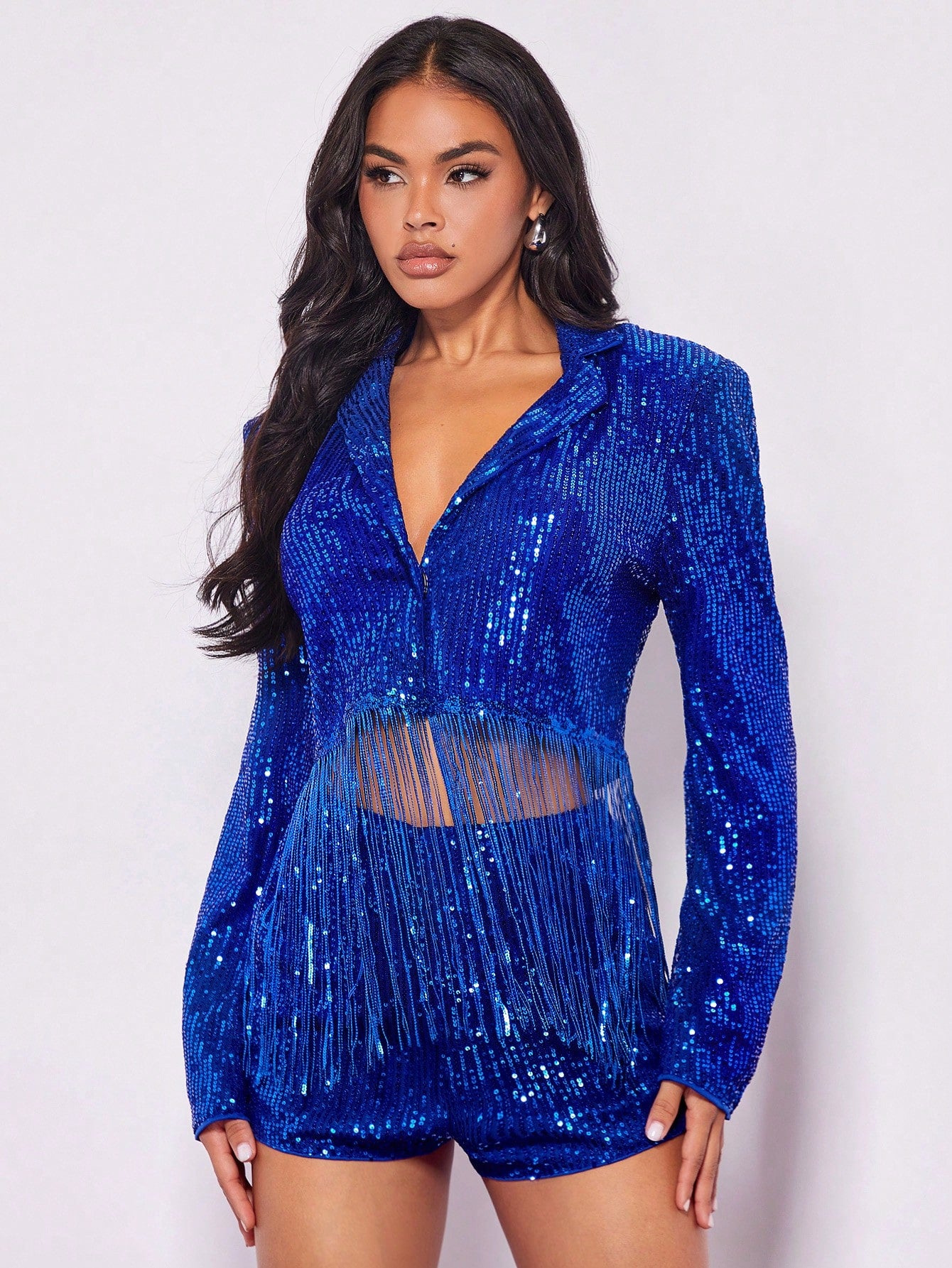 beautiful model posing on a white background wearing a Blue sequin jacket fancy dress