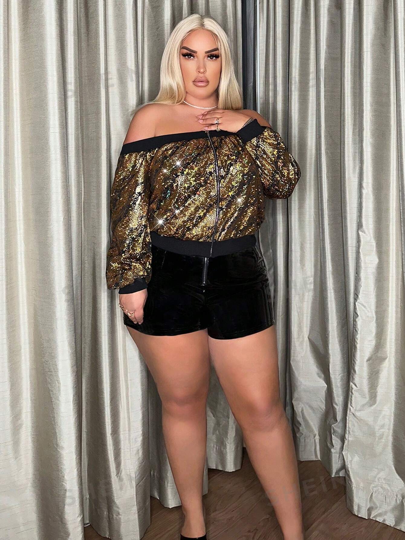 full body picture of a plus size model wearing a Plus size gold sequin jacket with a black velvet short