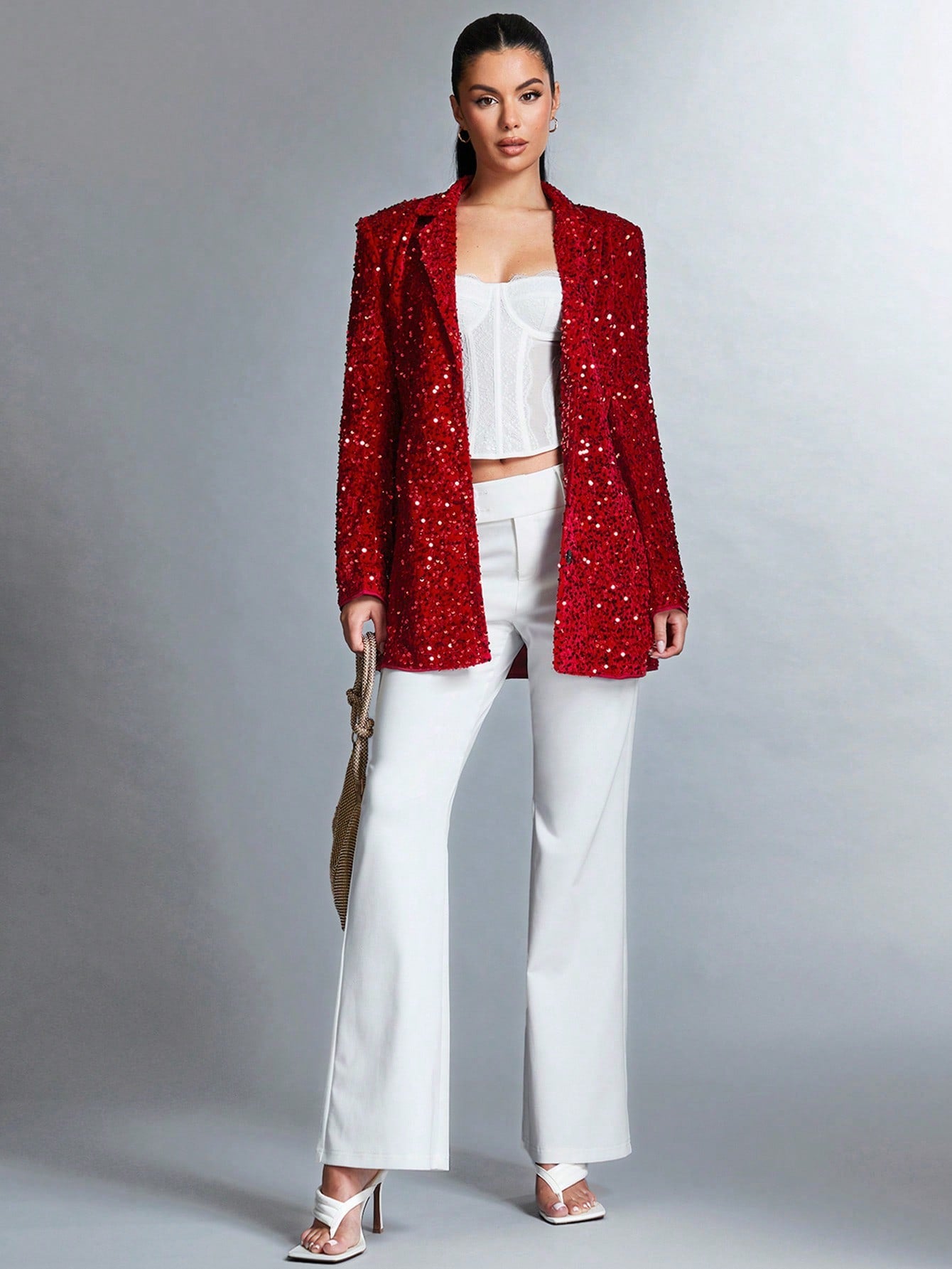 full body picture of a beautiful model posing in a white background, wearing a Sparkly red jacket paired with a straight white pants, a white corset and some trendy white heels