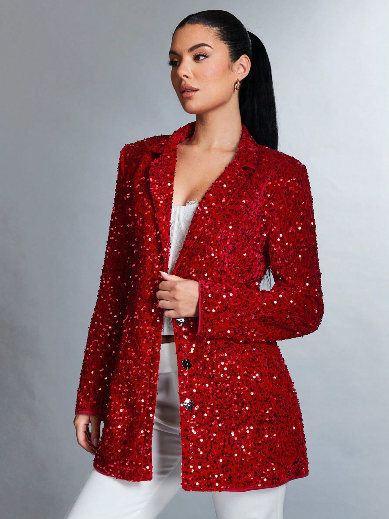 Sparkly red jacket from side profil worn by a brunette model with a ponytail