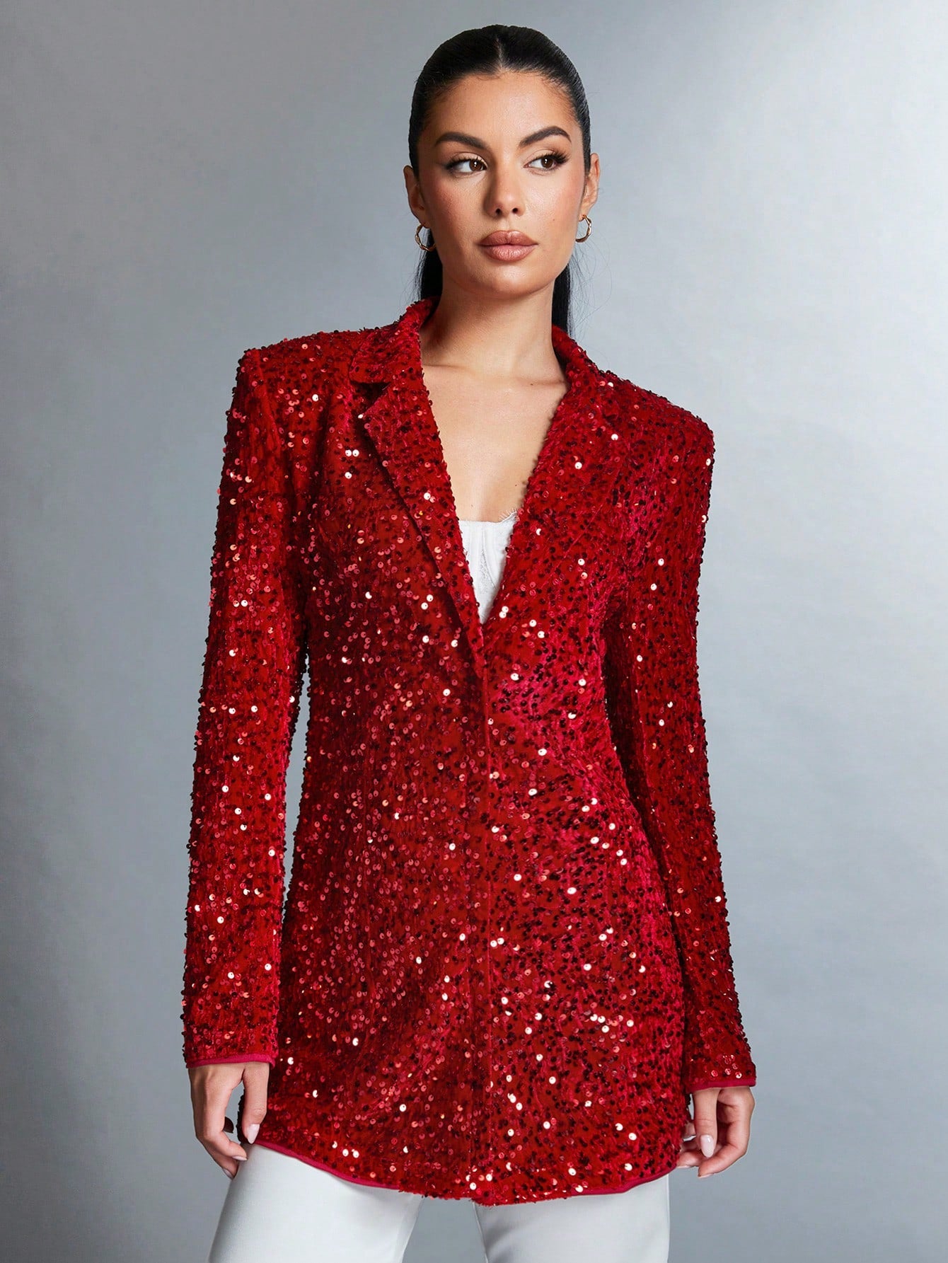 very chic Straight Sparkly red jacket closed paired with a white pants, worn by a beautiful model for a product picture