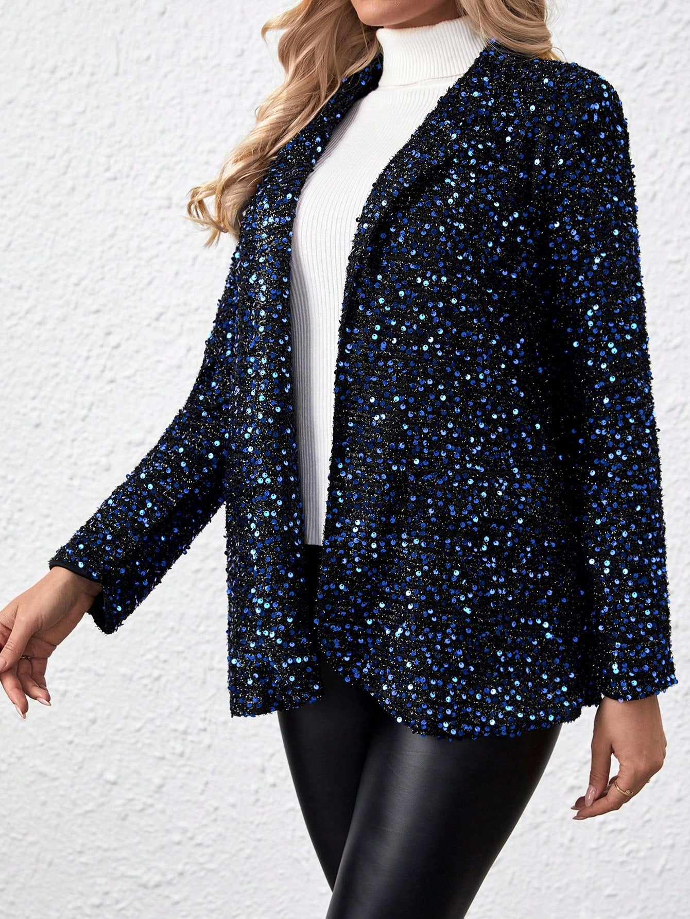 model wearing a Blue sparkly jacket walking for a professional pic