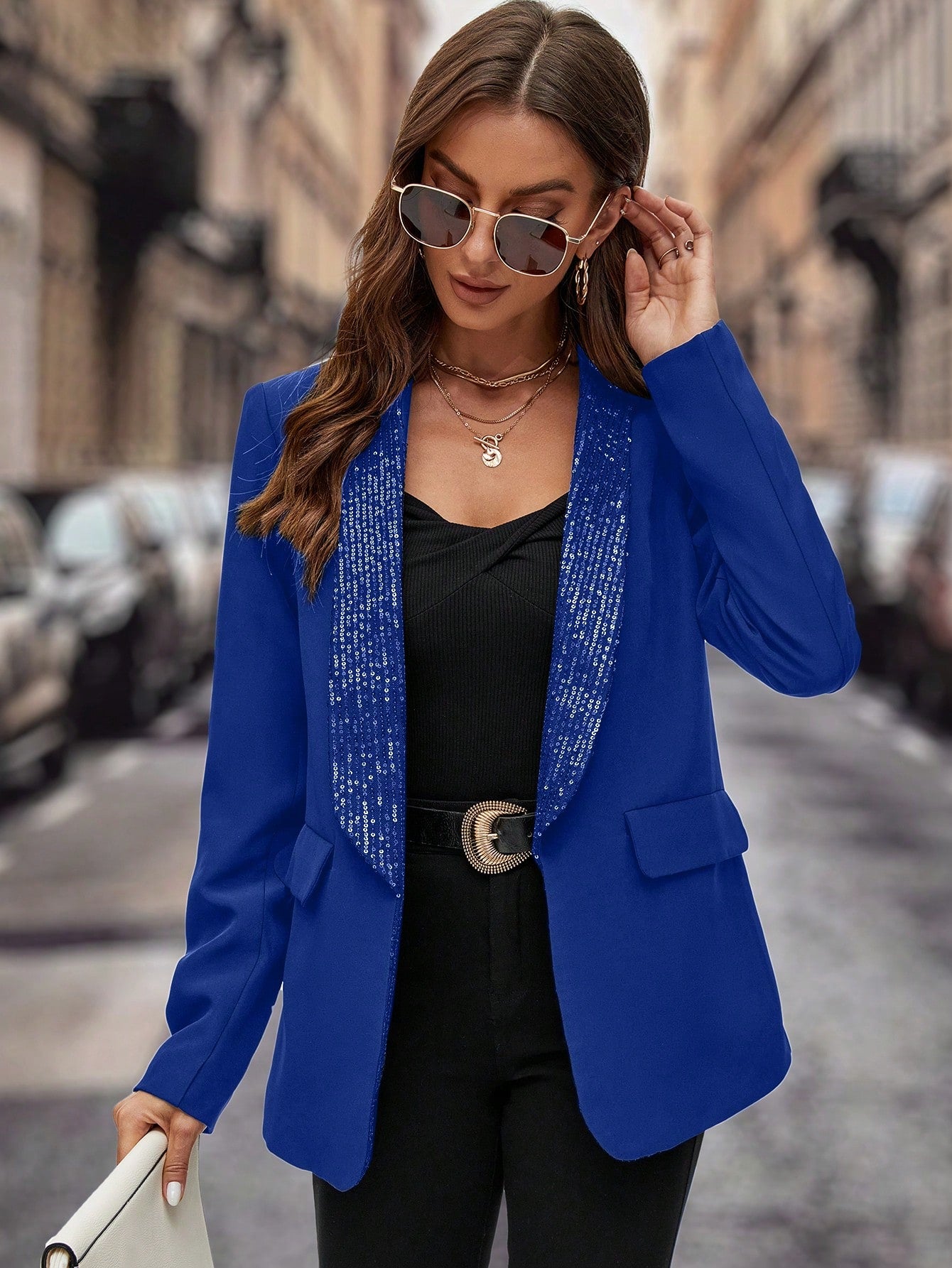 beautiful brunette model wearing a Blue sequin jacket blazer with a black pant, product picture took in the street