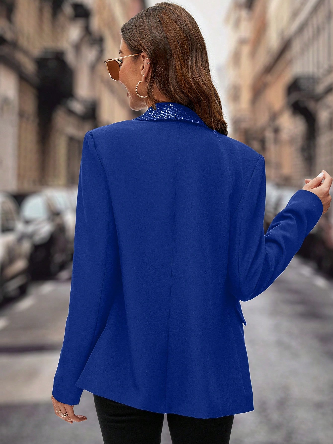 model from behind showing the back of her Blue sequin jacket blazer