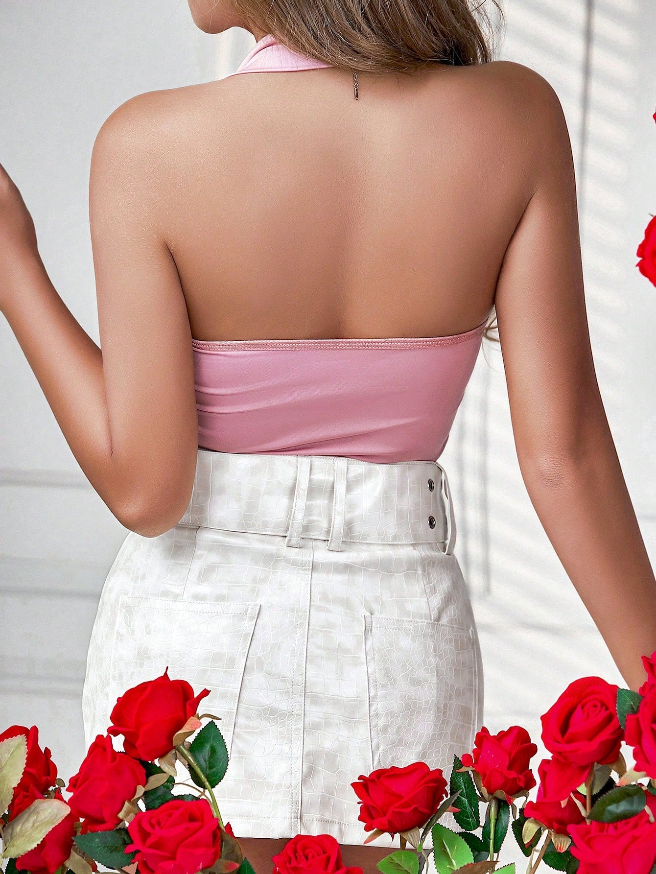 Barbie Pink Bodysuit paired with a white skirt, from behind