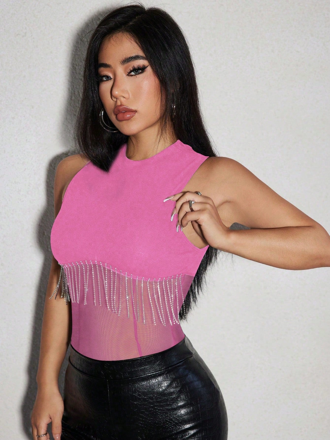 asian model wearing a Pink fringe bodysuit paired with a simili leather pants