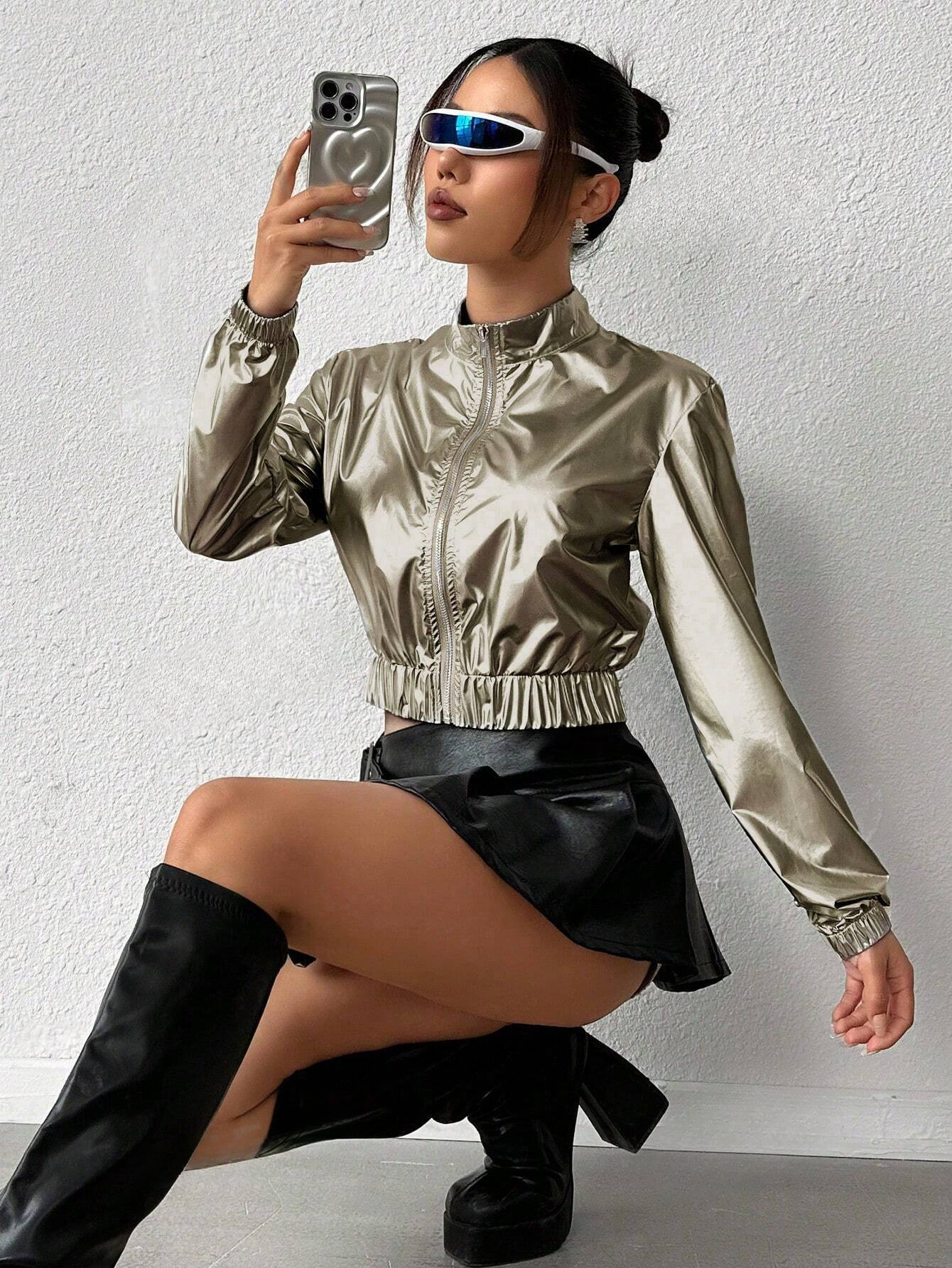 asian model taking a selfie with her outfit made of a Gold metallic jacket, a black faux leather and some black cuirass boots, chic and trendy outfit for a product picture